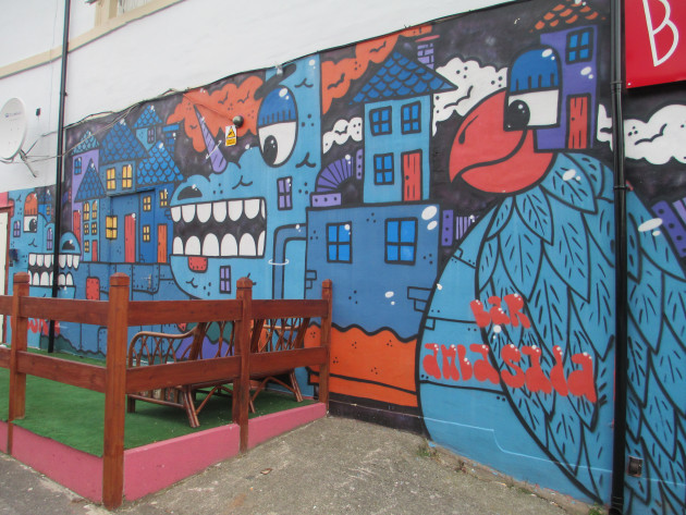 Mural featuring buildings and fantastical characters